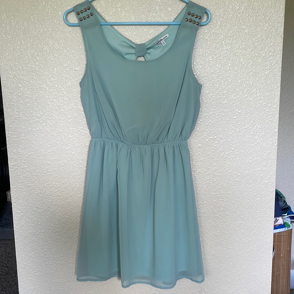 Light sage green dress, with peephole back and studded shoulders. Barely worn